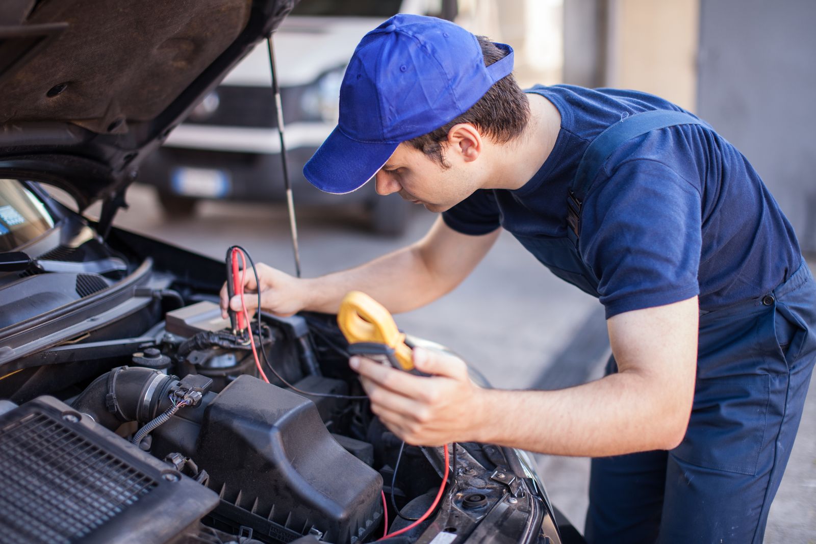 car electrician troubleshooting a car engine